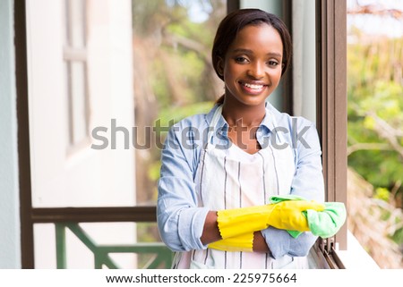 portrait of pretty african woman doing house chores