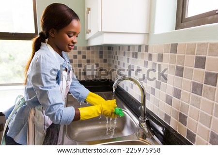 beautiful african american woman doing house chores