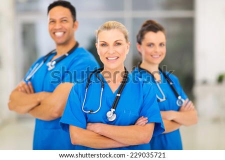 attractive senior female doctor leading medical team at hospital