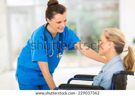 beautiful medical nurse comforting senior patient in office