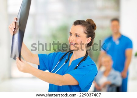 gorgeous  medical doctor holding patient\'s x-ray