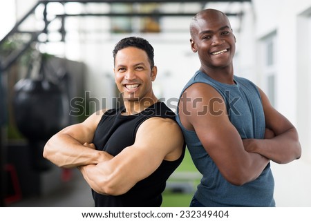 happy gym trainers with arms crossed