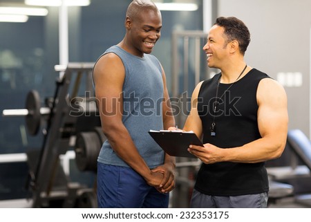 instructor explaining membership form to client in health club