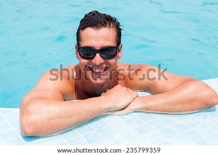 good looking man relaxing in a swimming pool