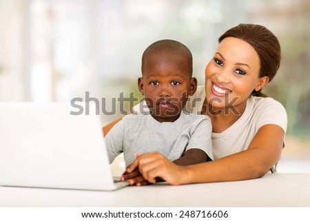 happy african  woman relaxing at home with her little boy