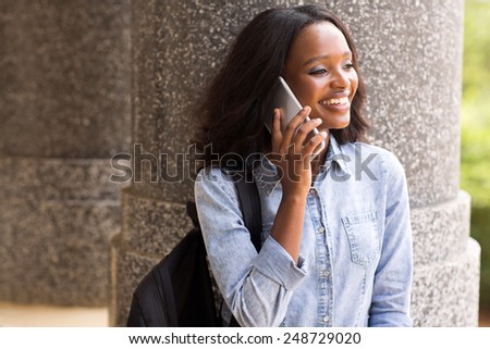 pretty african american college student making a phone call