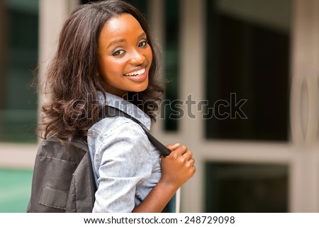 beautiful young african college girl carrying backpack