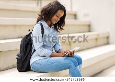 beautiful young college student using smart phone on campus