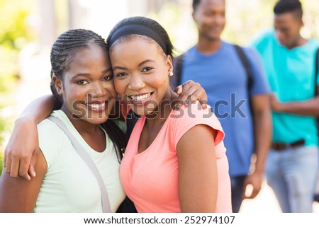 two pretty african american college friends on campus