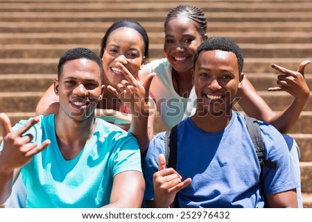 group of happy african american college students hand signs
