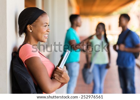 pretty female afro american college student looking away