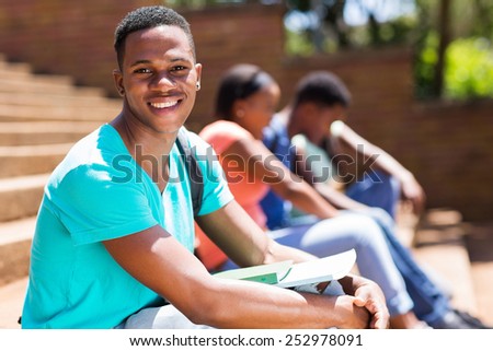 happy young male african college student on campus