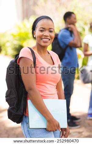 pretty female african college student with backpack on campus