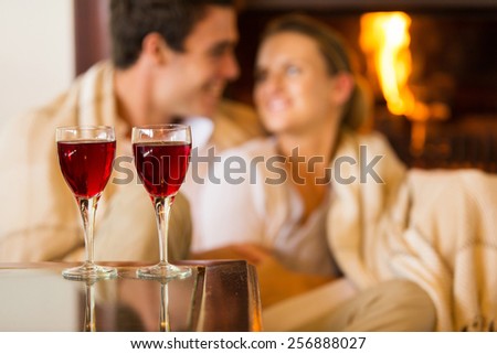 wine glasses on the table with couple on background