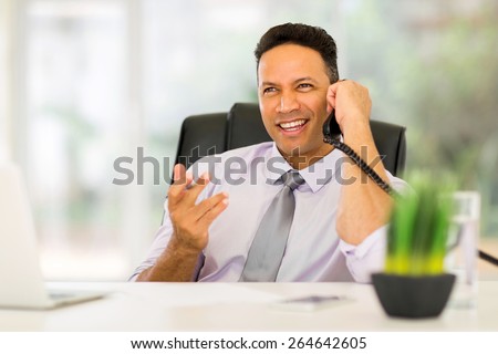 handsome office worker talking on telephone