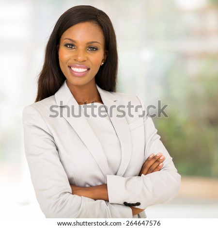 gorgeous african business woman with arms folded in modern office