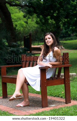beautiful young woman sitting on bench