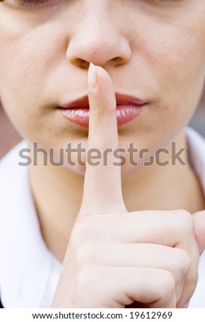 Shh. secret - Young caucasian beautiful woman with her finger over her mouth.