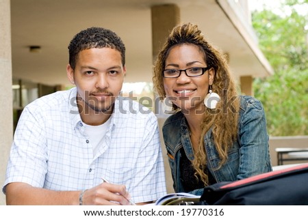 Two african college students friends study together outdoors