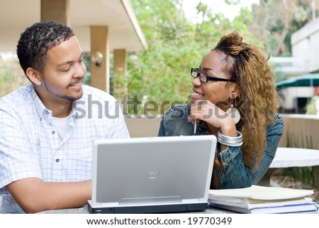 two african college students study computer together