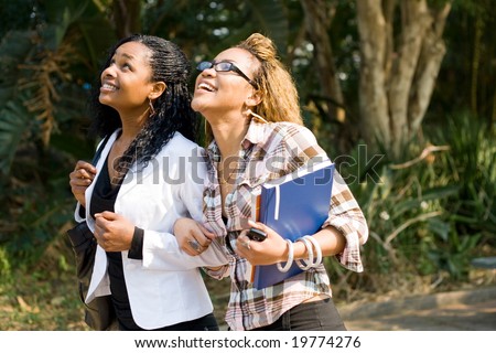 college students walking. stock photo : two african female college students walking to school