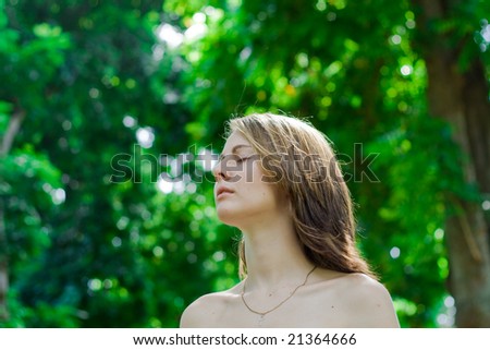 young beautiful happy woman deep breath in the green forest
