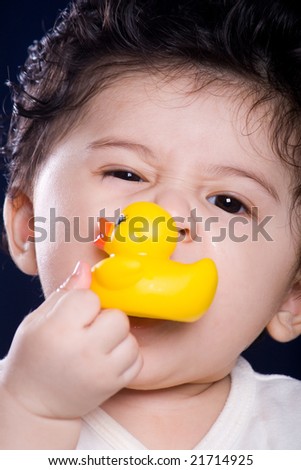 cute baby boy play with rubber duck toy