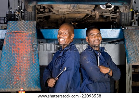 two african mechanic in side garage