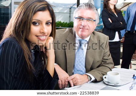 one senior business man and a young business woman meeting in coffee shop