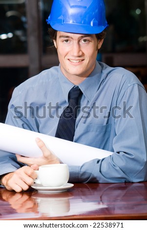 A handsome business construction manager in a cafe