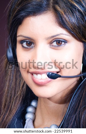 Closeup face of smiling indian business woman with headphones