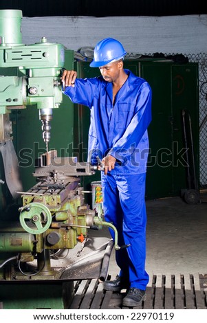 African machinist operating a drilling machine