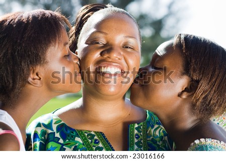 daughters kissing mother