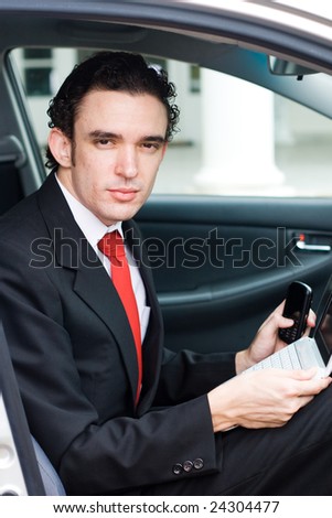 business man portrait inside a car