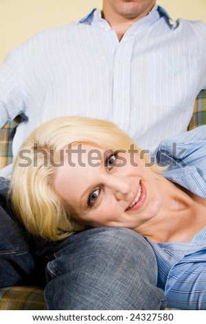 young blond woman rest her head on her boyfriend\'s lap