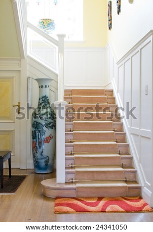 stairway in modern home, picture on the vase is ancient chinese art and is not copyright