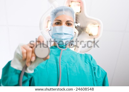 female doctor examining patient in operation room