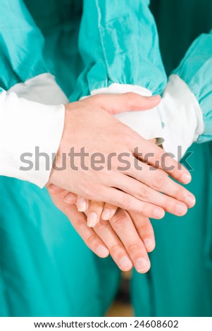 doctors with hands together to form a medical teamwork