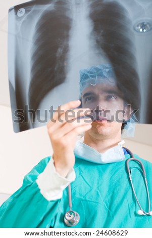 male doctor looking at x-ray film