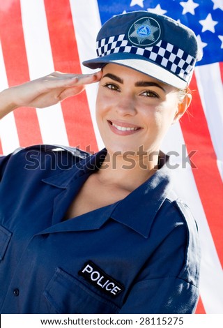 young american female police officer saluting, background is USA flag