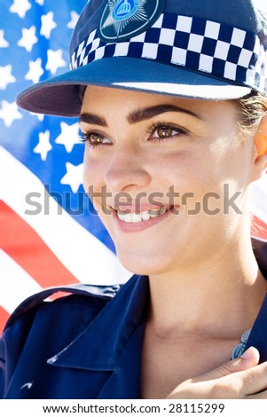 smiling american female police officer portrait, background is US flag