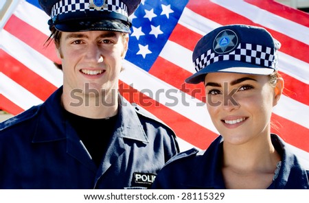 two police officer standing in front of american flag