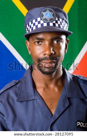 south african policeman portrait, background is south african flag