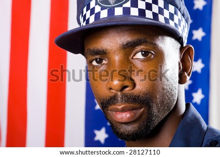 african american policeman portrait, background is USA flag