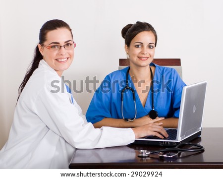 young female doctors sitting in front of a laptop computer