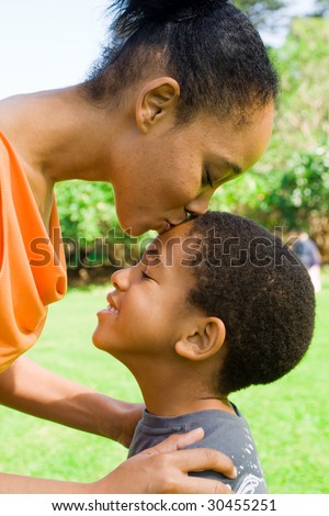 happy african american mother kissing  son