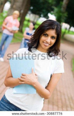 female college student in campus, background is her friends