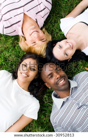 group of young people or college students lying on grass