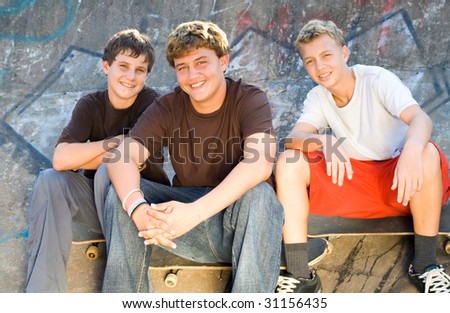 young skateboard boys playing outdoors