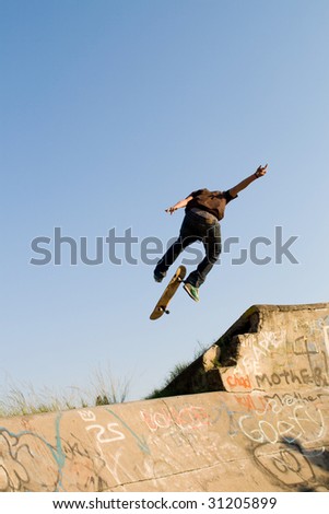 teen boy skateboarder playing on concrete ramp
